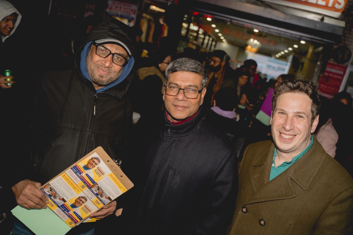 Shamsul Haque canvassing with campaign supporters at a community event in Queens